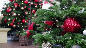 Video review of a decorated Christmas tree close-up with red toys and garlands
