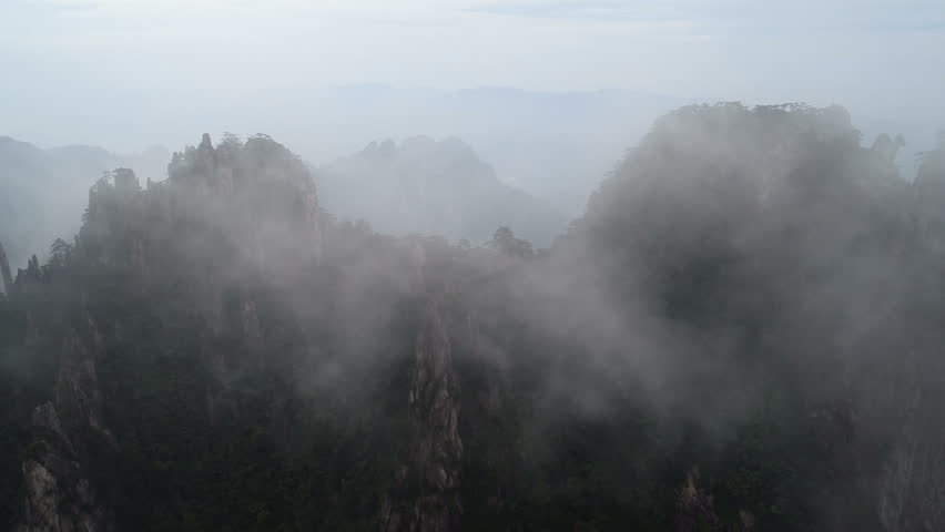 Aerial view of breathtaking mountain landscape covered in fog and mist, spectacular view of Huangshan national park, on of China