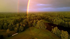 An Aerial Drone Shot of a Double Rainbow Over a Forest Landscape Countryside in Latvia. - Powered by Shutterstock - Get 15% off with code: PIKWIZARD15