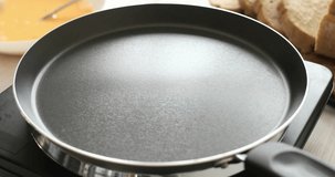 Butter in a hot frying pan. Bubbles and steam of melted butter. Cooking food. A series of videos of Bread with Egg Recipe.