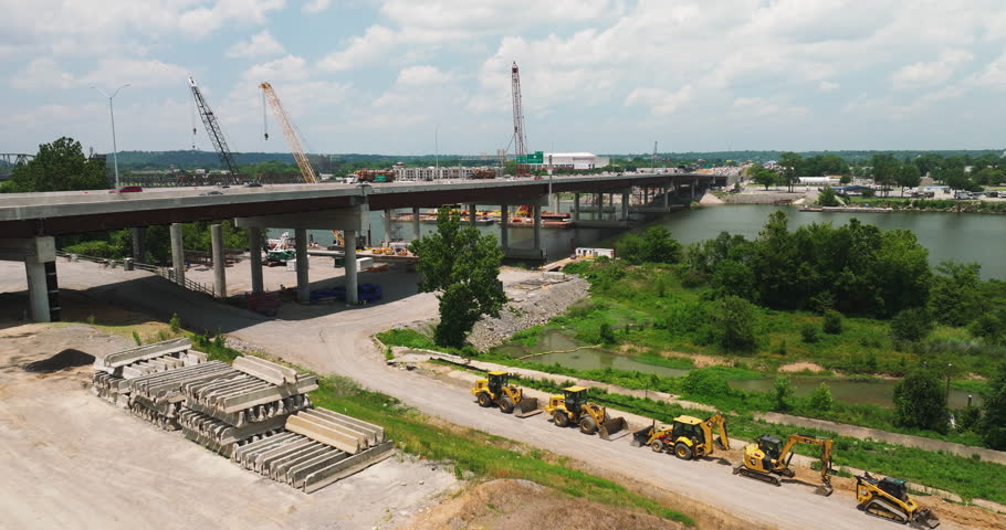 Cranes At Bridge Construction Site Across Arkansas River In Little Rock, Arkansas, USA. wide aerial Royalty-Free Stock Footage #1108560323