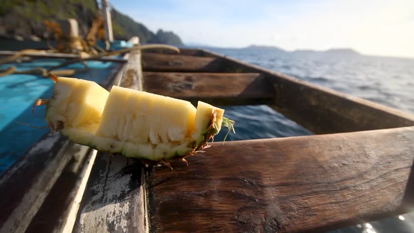 A sliced pineapple on a boat while sailing in El Nido Royalty-Free Stock Footage #1108564453