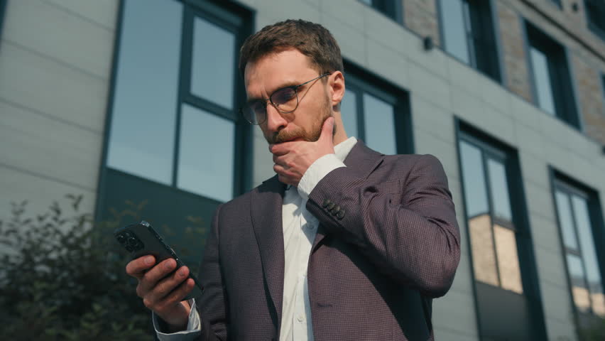 Confident male businessman Caucasian man employer real estate agent business developer in city near office outdoors take mobile phone from jacket pocket reject incoming call unpleasant spam message - Powered by Shutterstock - Get 15% off with code: PIKWIZARD15