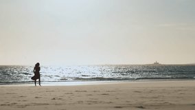 Graceful young woman in red dress dancing alone on the beach at early sunset - Powered by Shutterstock - Get 15% off with code: PIKWIZARD15
