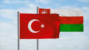 Oman and Turkey flag waving together in the wind on blue sky, cycle looped video, two country cooperation concept