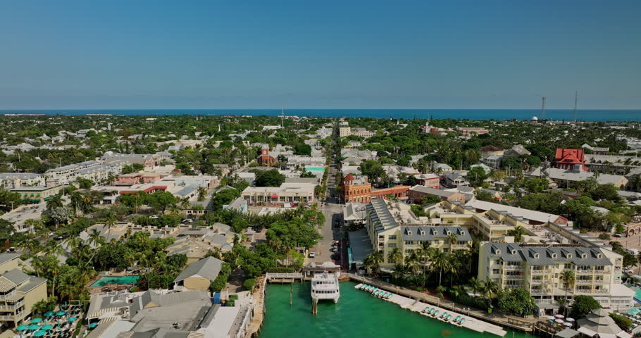 Key West Florida Aerial v14 cinematic drone soaring above Duval street across the town capturing vibrant island cityscape at daytime in summer - Shot with Mavic 3 Cine - April 2022