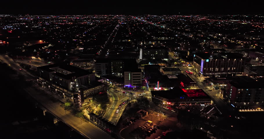 Tucson Arizona Aerial v13 establishing shot flyover and around downtown area capturing night cityscape of the desert city and busy traffics on E Congress street - Shot with Mavic 3 Cine - March 2022