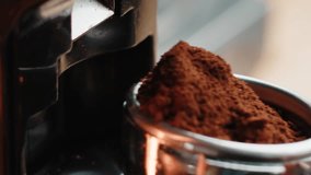 Professional barista worker use grinder machine to grind fresh coffee beans for make hot beverage at coffee cafe shop. Extreme macro close up - Powered by Shutterstock - Get 15% off with code: PIKWIZARD15