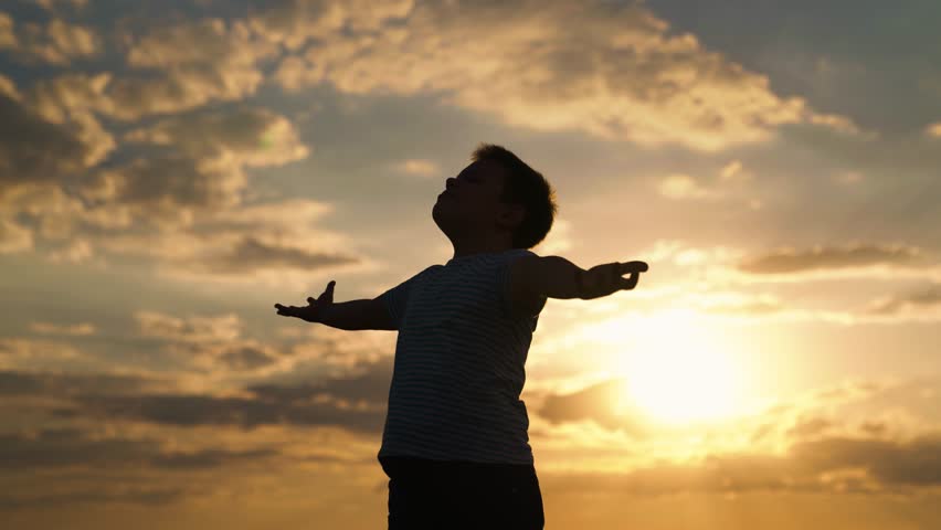 Boy Child raised his hands to sky in park at sunset, childhood dreams. Happy family. true faith. Little boy prays against background of sky, sun. Religion and god, Child boy plays in park against sky | Shutterstock HD Video #1108574133