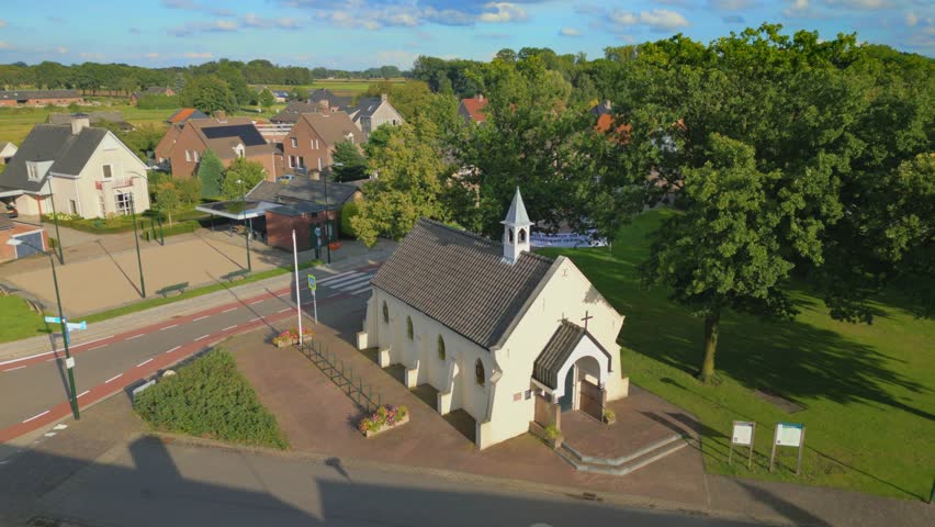 Orbit drone shot of Cornelius chapel in Brabant rural Dutch village Gastel