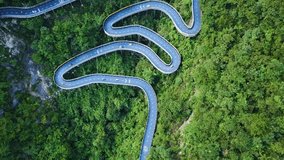 Top View of hairpin bend Kart Race Track in Amusement Park, Tonglu, China. race car circuit on sunny day. kart racing field with dense trees. Karting racing sport concept shot.