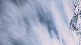 Stepantsminda, Gergeti, Georgia. Peak Of Mount Kazbek Covered Snow And Famous Gergeti Trinity Tsminda Sameba Church In Winter Landscape. Beautiful Georgian Winter Nature Landscape. Vertical Footage.