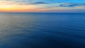 In this serene and magical moment captured from the drone's aerial view, the sea and sky become a testament to the wonder of nature's artistry, a fleeting yet unforgettable symphony of color, light.

