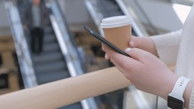 Young woman using smartphone at mall. Caucasian girl looking at mobile phone in her hand. Communication, work or study, connection, mobile apps, technology, lifestyle concept 4K