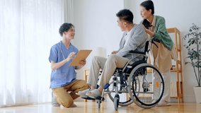 Nursing staff talking to an elderly person sitting in a wheelchair. - Powered by Shutterstock - Get 15% off with code: PIKWIZARD15
