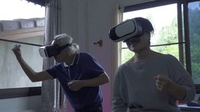 Old man and woman exercising boxing with VR glass, slow motion shot