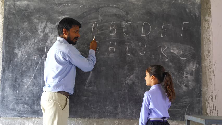 Indian Rural elementary school teacher teaching kids some lesson in the class with excitement and joy. Royalty-Free Stock Footage #1108603325