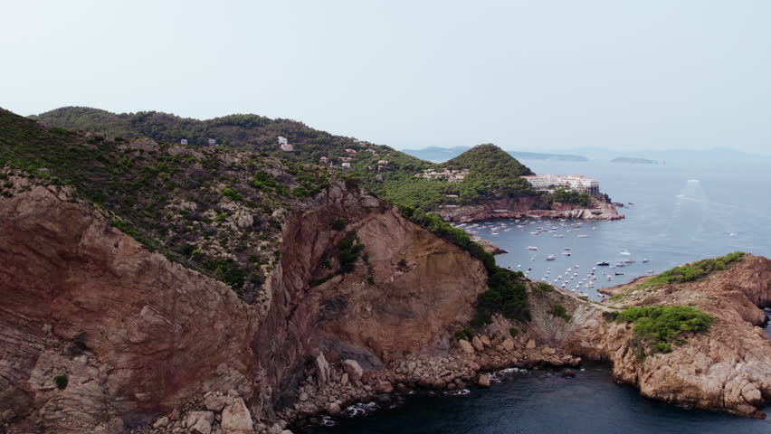 Drone fly over mountains, revealing view on Costa Brava, small village of Begur. Popular holiday destination in Spain, summer vacation spot on Mediterranean sea | Shutterstock HD Video #1108604169