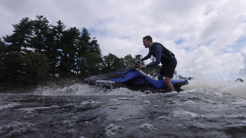 Jet ski rider doing a wheelie on a modern trick rig