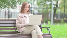 Online Video Chat by Senior Old Woman on Laptop Outdoor