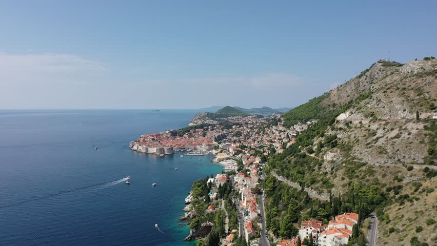 Dubrovnik old town. Aerial view of historic city of Dubrovnik in Croatia. Famous tourist attraction in the Mediterranean. Summer. Old port by the Adriatic sea.