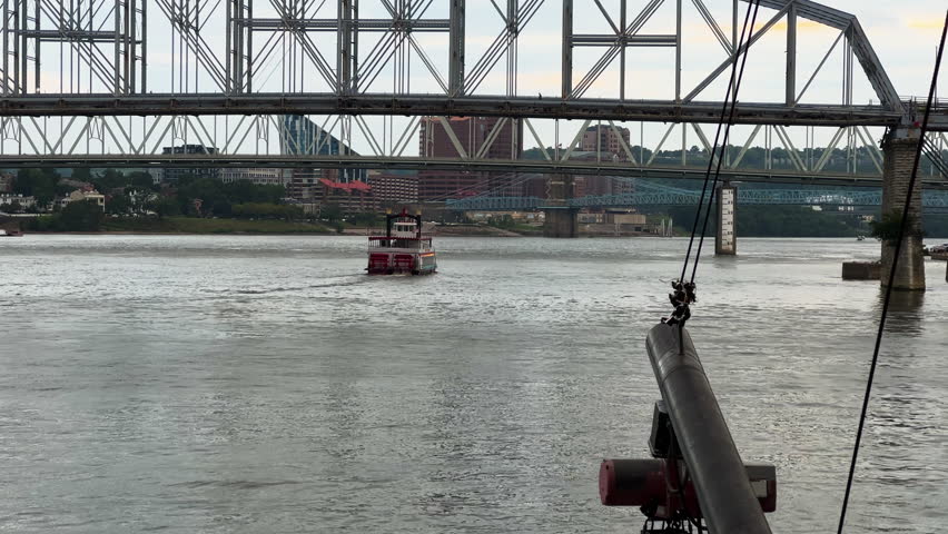 Cruise Ships Cross Over The Ohio River And Bridges Connecting Cincinnati, Ohio, And Covington, Kentucky In The United States. Wide Shot