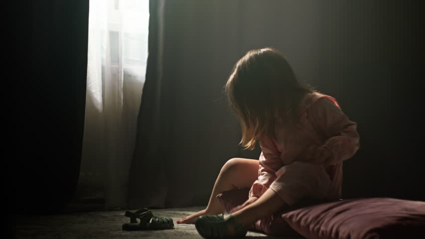 A child girl puts on shoes sitting on the floor at home. The child gets dressed for a walk outside. High quality 4k footage Royalty-Free Stock Footage #1108612585
