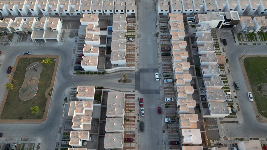 aerial view of a suburb in mexico with dozens of subdivision houses, parks, avenues and cars