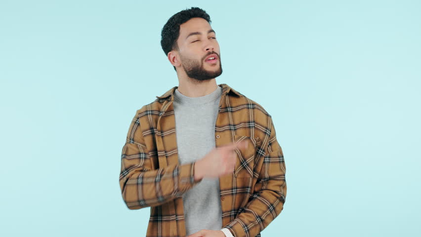 Man, mockup and pointing in studio for marketing, advertising or promotion on blue background and approval face. Decision, person and choice or option for product placement of work presentation