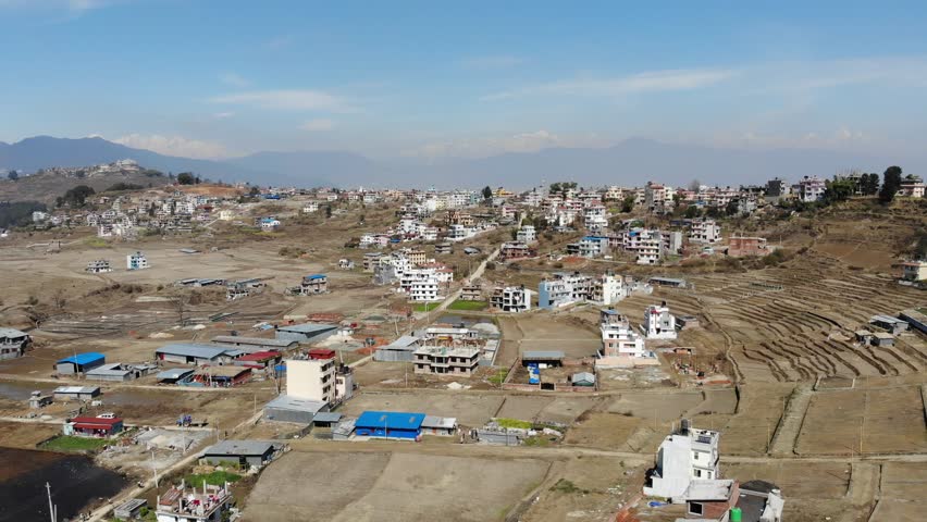 Aerial perspective of Kathmandu, Nepal showcasing a forward rise and pan shot, providing a glimpse of the urban landscape and city
