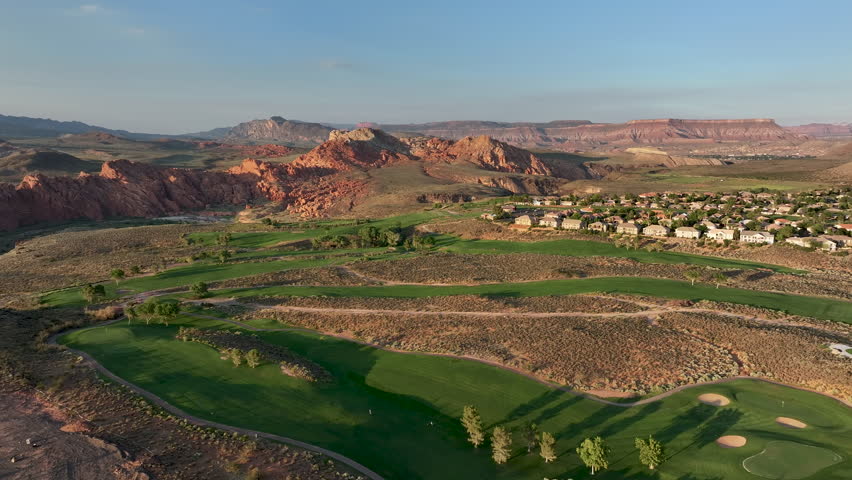 Aerial desert golf course green St George Utah fast. Aerial subdivision neighborhood residential golf course and homes. Recreation and retirement sport. Residential Housing boom economy. Desert field. Royalty-Free Stock Footage #1108623961