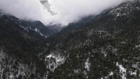 4k Drone landscape video of moody snowy mountain forest Olympus Greece