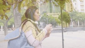 Animation of spots of light over caucasian woman eating take away lunch in city street. Lifestyle, urban living and happiness concept digitally generated video.