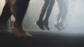 Unrecognized people skipping rope exercising together at gym in slow-motion. Close-up of young people's foot jumping - Powered by Shutterstock - Get 15% off with code: PIKWIZARD15