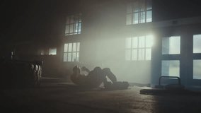 Strong young man doing sit up workout on the floor at gym. Gym equipments are placed next to the man - Powered by Shutterstock - Get 15% off with code: PIKWIZARD15