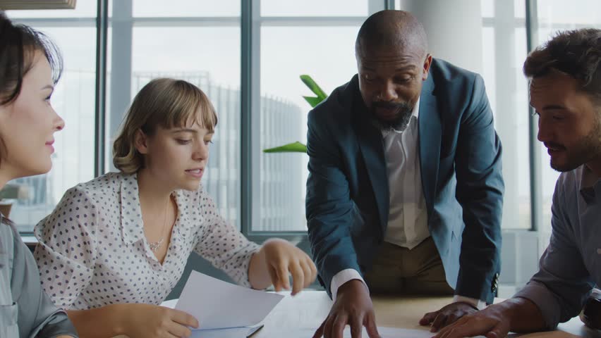 Group of multiracial colleagues talking and gesturing during business meeting in office Royalty-Free Stock Footage #1108633557
