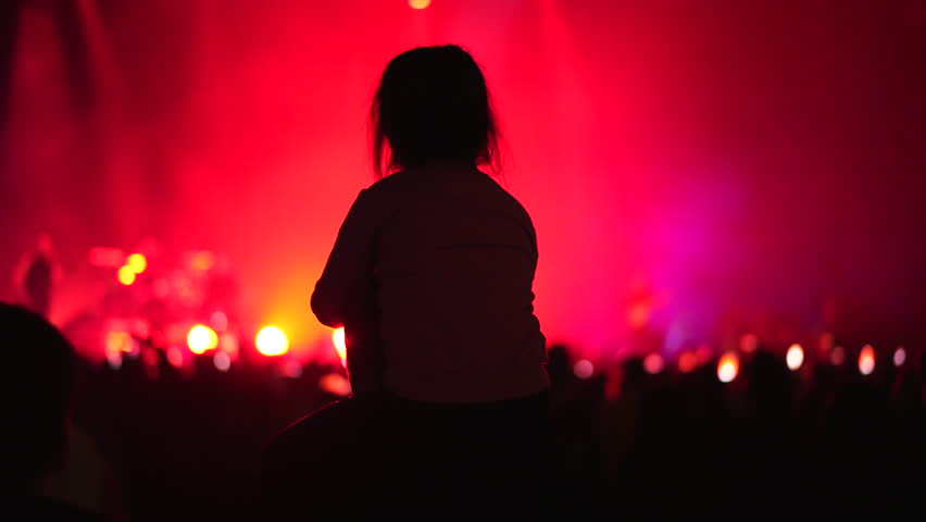 Happy little girl sit her dad shoulders. Small kid have fun live music concert. Cool neon night. Child enjoy disco party. Joyful childhood. Daughter hang out pop show. Family band fan. People raise up Royalty-Free Stock Footage #1108637629