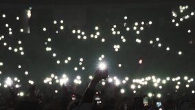 Many fun people lift hand up hold cell phone flash light. Fan crowd wave flashlights. Epic live music concert atmosphere. Big open air k pop arena. Cool night fest. Lot joy men hang out. Kpop chill. - Powered by Shutterstock - Get 15% off with code: PIKWIZARD15