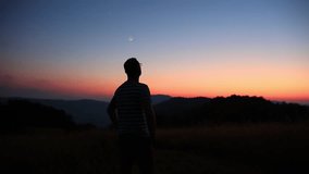 Man looking at the starry skies, crescent Moon, planets and stars in blue hour twilight time - Powered by Shutterstock - Get 15% off with code: PIKWIZARD15