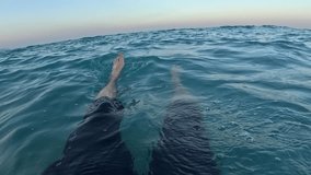 summer mood, relaxation by the sea on Turkish Riviera. Man floating on water in wavy Mediterranean Sea in Antalya, Turkey, personal point of view - Powered by Shutterstock - Get 15% off with code: PIKWIZARD15