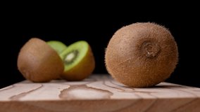 4K Video of cutting kiwifruit on a board.