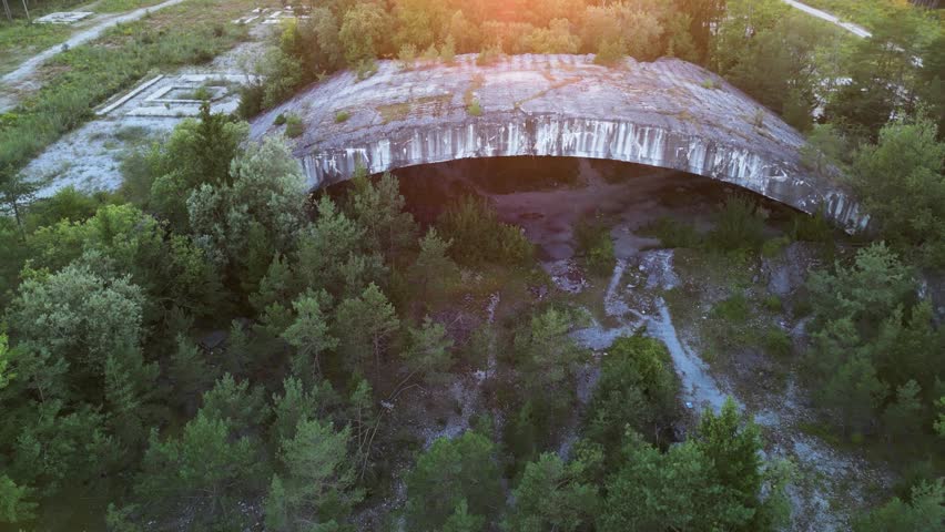 Drone flight over ruins of old nazi air bunker Weingut 1 during sunset