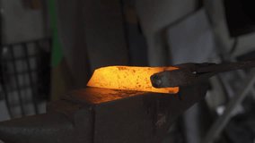 Blacksmith hitting a hot metal rod, 4k footage
