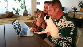 This Christmas, a heartwarming video call connected a loving gay couple, separated by distance, as they shared their joy and festive spirit while their adorable dogs brought extra warmth to their virt - Powered by Shutterstock - Get 15% off with code: PIKWIZARD15