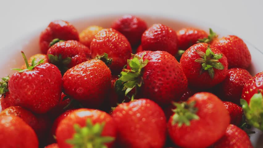 Juicy ripe red strawberries in a plate rotate in a circle. Close up | Shutterstock HD Video #1108657493