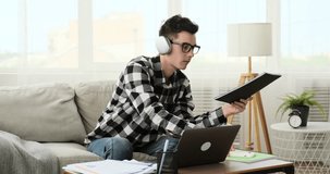 Positive Man Engaging in Video Call while Juggling Papers