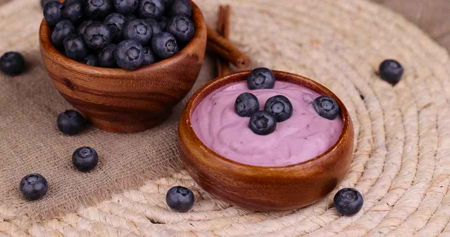 Blueberry yogurt with the addition of ripe blueberries, delicious and fresh natural yogurt with the taste and berries of blueberries | Shutterstock HD Video #1108660249
