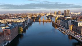 City of Berlin, Germany from above. Aerial cityscape view showing architectural landmarks Oberbaum Bridge, TV Tower and Berlin Cathedral at sunrise. Drone flight on the river Spree.