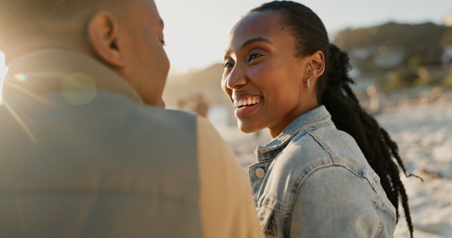 Beach, talking and black couple with love, smile and marriage with commitment, lens flare and bonding. Romance, vacation or man with woman, seaside holiday and romantic with relationship and sunshine Royalty-Free Stock Footage #1108665739