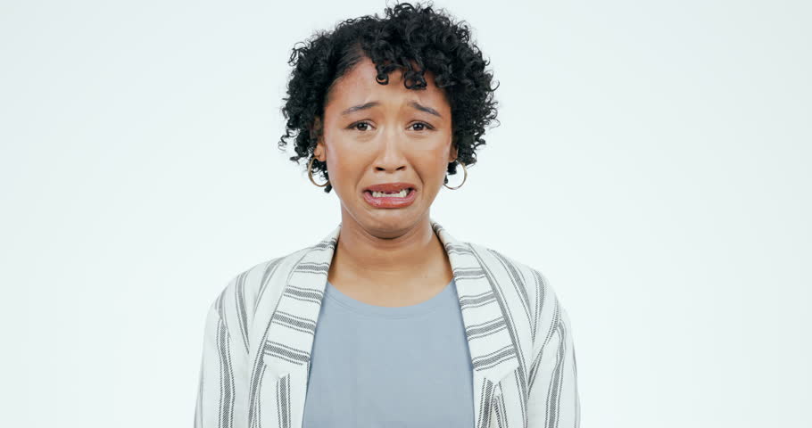 Crying, depression and face of sad woman in studio with stress, fear or mental health crisis on white background. Tears, portrait and lady model with anxiety, broken heart or mistake, trauma or grief | Shutterstock HD Video #1108666465